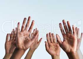 Raise your hands in support of each other. Shot of a group of hands reaching up against a white background.