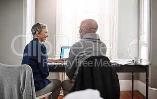 Are you glad we put that extra money away. Shot of a senior couple working on their finances at home.