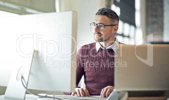 Keeping up with the changes in technology and styles. Cropped shot of a businessman working on his computer in an office.