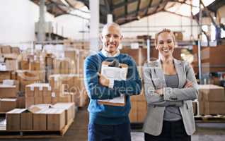 Your shipment is in capable hands. Portrait of two managers standing in a distribution warehouse.