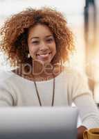 My career is my bliss. Portrait of a young businesswoman sitting at her laptop in an office.