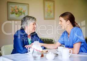 Tell me all about it. Shot of a resident and a nurse at a retirement home.