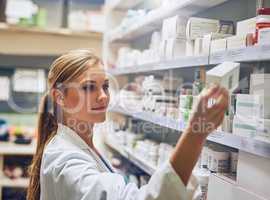 I know exactly the medication thatll help you. Shot of a pharmacist looking at medication on a shelf.
