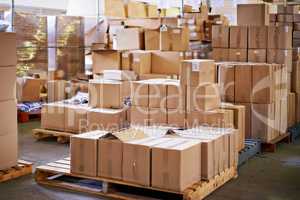 Pallets ready to go. Shot of stacked boxes in a large distribution warehouse.