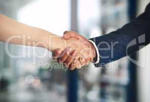 Strengthening business with a solid alliance. Cropped shot of a businessman and businesswoman shaking hands at work.