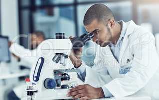 Always question, always wonder. Cropped shot of a young male scientist working in his lab.