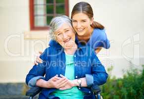 Giving care to the best of her abilities. Shot of a resident and a nurse outside in the retirement home garden.