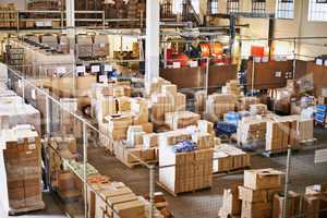 Shipping logistics. Shot of the interior of a large packaging and distribution warehouse.