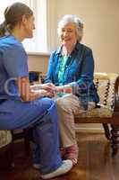 Shes grateful for the support. Shot of a resident being consoled by a nurse in a retirement home.