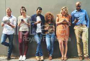 Social networking helps reach people easier and quicker. Shot of a diverse group of people social networking outside.