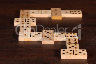 domino pieces on the brown wooden table background