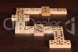 domino pieces on the brown wooden table background