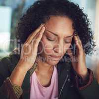 I cant take this pain anymore. Shot of a mature woman experiencing a headache.