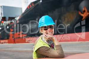 My attitude is never to be satisfied. A confident young woman resting her chin on her hands next to a ship..