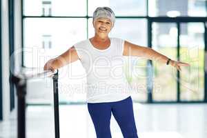 Exercising wth a smile. Shot of a senior woman working out indoors.