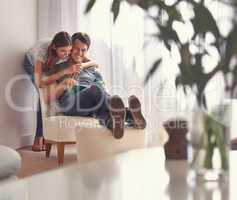 Being together is the only important thing. Shot of an affectionate young couple relaxing at home.