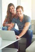 Being together is the most important thing. Shot of a young couple using a laptop at home.