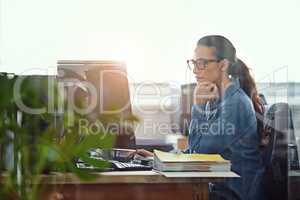 Shes a diligent worker. Cropped shot of a businesswoman working at her desk.