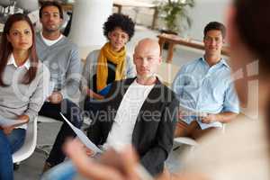 Giving their full attention. A group of colleagues sitting in a business meeting.