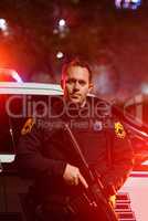 Some situations require more force than others. Cropped portrait of a handsome young policeman standing with his assault rifle while out on patrol.