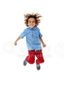 Jumping for joy. Studio shot of a cute little boy jumping for joy against a white background.
