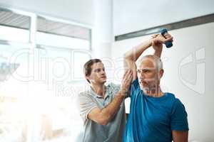 These exercises are very important for your recovery. Shot of a young male physiotherapist helping a client with stretching exercises in his office during the day.