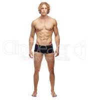 He just oozes masculinity. A full length portrait of a muscular young man, isolated on white.