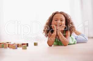 I think Ive mastered these alphabet blocks. Shot of a cute little girl playing with alphabet blocks.