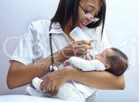 Making a caring contribution to society. Shot of a healthcare worker giving formula to an infant who has a cleft palate.