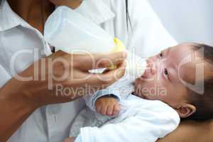 Its feeding time. Shot of a healthcare worker giving formula to an infant who has a cleft palate.
