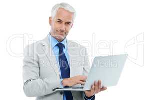 Its time for business. Studio shot of a mature businessman working on a laptop isolated on white.