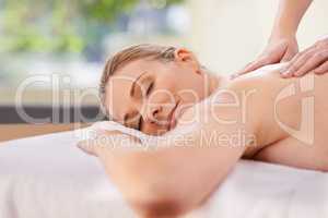 Experience total bliss. Cropped shot of a woman in a day spa relaxing on a massage table.