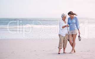 Discoveries with my daughter. Shot of a senior mother and her adult daughter exploring the beach.