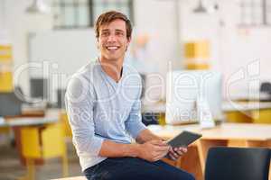 I wonder whats trending in the design world. Shot of a designer using a digital tablet while working in an office.