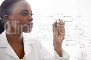 The world of molecules. Shot of a handsome male scientist drawing chemical bonds on a glass surface.