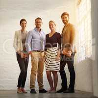 The best in the business. Full length portrait of a business team standing in their office.