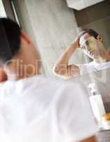 What should I start with this morning. Cropped shot of a young man looking at himself in the mirror.