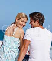 So happy to have him in my life. Rearview shot of a loving couple sitting together at the waters edge.