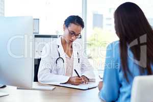 Im going to write a referral for you. Shot of a young doctor having a discussion with a patient in her consulting room.