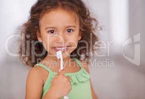 Good habits start when you are young. Portrait of an adorable little girl holding a toothbrush.