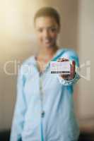 Need a personal trainer. Shot of a gym trainer showing her identification card.