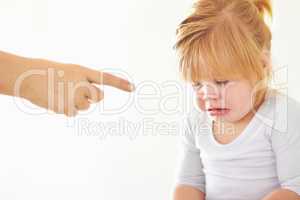 Discipline - Its never fun.. A cute baby girl crying while her mother points at her.