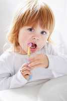 Dental hygiene at a young age. Portrait of a cute baby brushing her teeth.