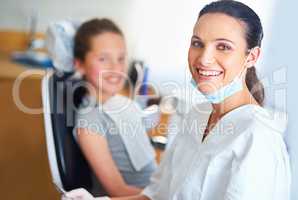 I always try to put my patients at ease. Portrait of a female dentist and child in a dentist office.