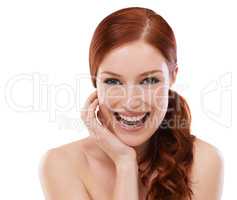 Theres a touch of elegance about her beauty. Studio shot of a redheaded woman isolated on white.