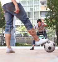 No one gets past him. Rear-view of a player ready to kick a soccer ball while the goalie stands ready.