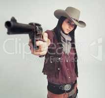 Im the sheriff around these parts.... Full-length shot of an attractive young woman in cowboy attire.