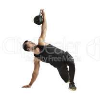 Train insane or remain the same. Studio shot of a fit young man working out with a kettle bell against a white background.