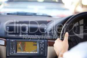 Your destination awaits.... Cropped image of a gps navigation system and a mans hands on the steering wheel of a car.