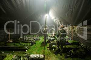 Soldiers getting ready to bunk down inside of their large tent - This is the real thing from KFOR, Kosovo 1999. This image is part of our historic collection. The digital cameras available back then where very bad, so expect exceptionally bad image qualit